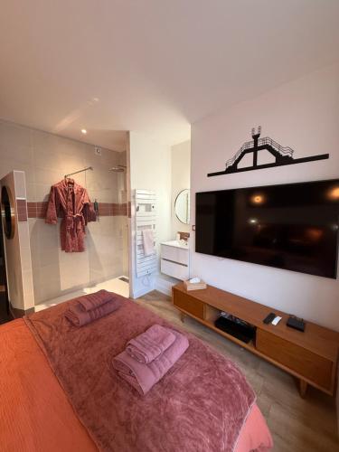 a bedroom with a bed with two purple pillows on it at Le Plongeoir, intra-muros in Saint Malo