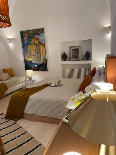 a bedroom with a bed and a couch at Dimora Lùmina in Gallipoli