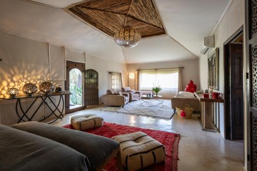 a large living room with a couch and a table at Domaine Darsyada Boutique Hôtel Deluxe Et Spa in Marrakesh