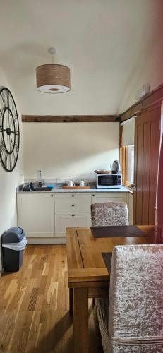 a kitchen with a table and chairs in a room at Sabine Barn in Oxford