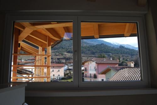 a window with a view of a city at Dimora Concordia in Calavino