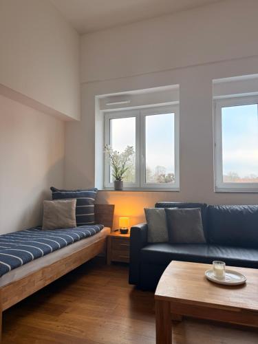 a living room with two blue couches and a table at Westwind 2 in Steinfeld