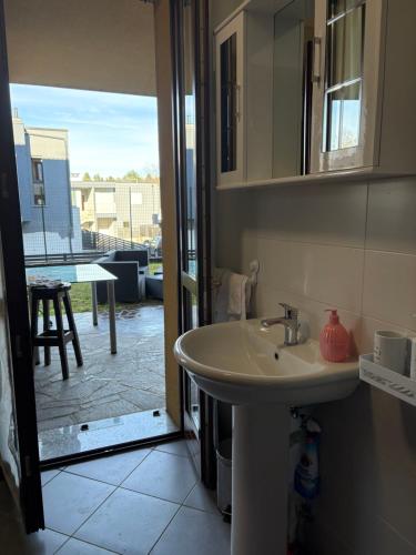 a bathroom with a sink and a view of a patio at Casa Menotti in Carate Brianza