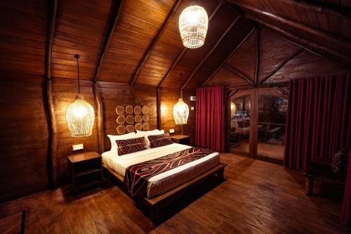 a bedroom with a large bed in a wooden room at Gaga Bees Udawalawe in Udawalawe