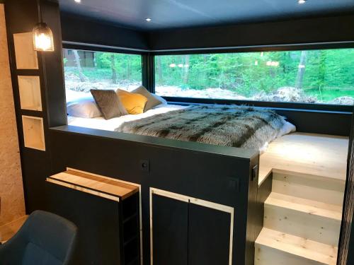 a bed in a small room with a window at Forest Cube in Oignies