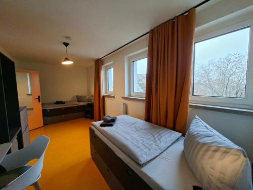 a bedroom with a bed with a window and a bed sidx sidx sidx at KulturHaus Locktow in Locktow