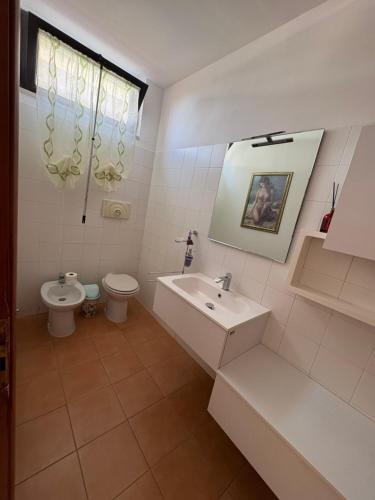 a bathroom with a sink and a toilet at Rosa's Rooms in Matera
