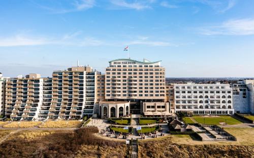 a large white building with a flag on top of it at Grand Hotel Huis ter Duin in Noordwijk aan Zee