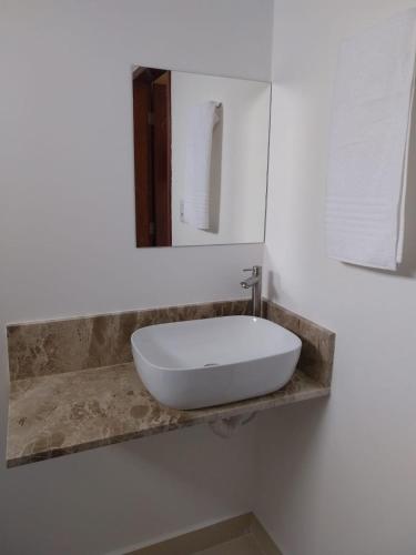 a white sink on a counter in a bathroom at Pousada Serra do Torreão in João Câmara