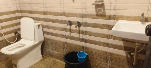 a bathroom with a toilet and a sink at Funky Art Beach House in Alleppey