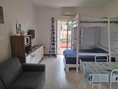 a living room with two bunk beds and a couch at Maralis Portorosa in Furnari