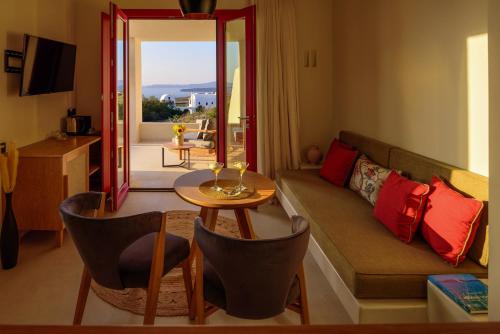 a living room with a couch and a table at Potnia Theron Suites in Akrotiri