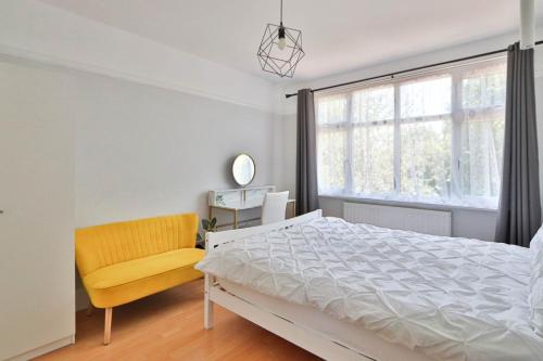 a bedroom with a bed and a chair and a window at Twin home with free parkings, Surbiton, Kingston upon Thames, Surrey, Greater London, UK! in Surbiton