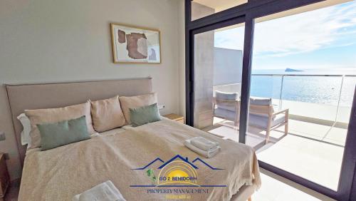 a bedroom with a bed with a view of the ocean at Nini Sunset Sailor Luxury Apartment in Benidorm
