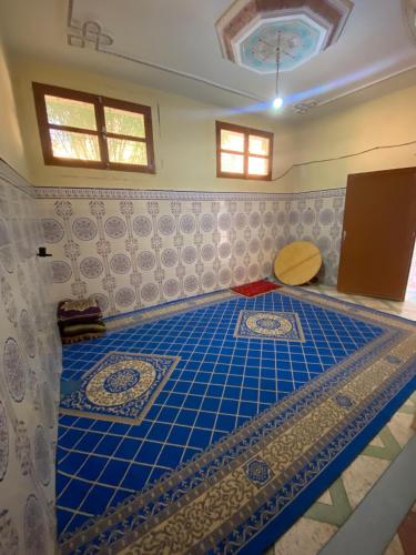 a room with a blue tiled floor in a room at GUESTS Of TATA in Tatta