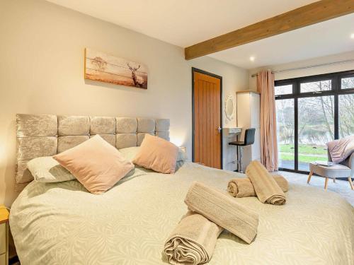 a bedroom with a large bed with two pillows on it at 2 Bed in Norwich oc-73624 in East Harling