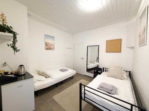 a room with two beds and a mirror at CityStay Montabaur in Montabaur