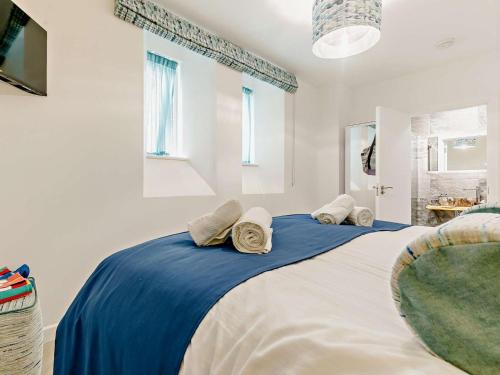 a bedroom with two beds with blue and white sheets at 3 Bed in Newquay oc-90070 in Newquay