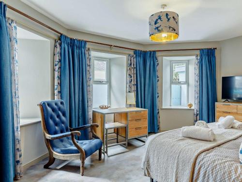 a bedroom with a bed and a chair and a desk at 4 Bed in Newquay oc-90069 in Newquay