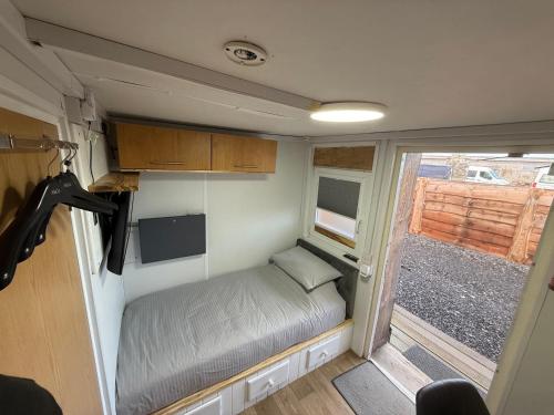 a small room with a bed in a trailer at Thurso Accommodation in Castletown