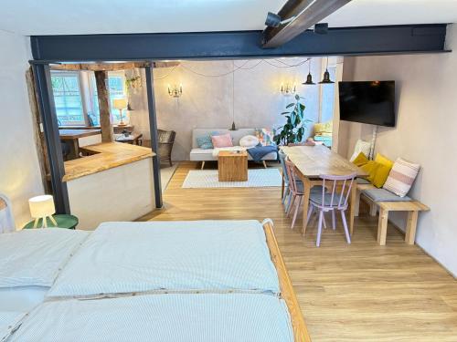 a room with two beds and a table and a couch at Katzenbachlädle in Rottenburg