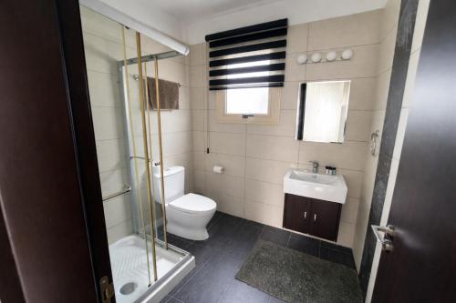 a bathroom with a toilet and a glass shower at Villa Dolce Vita in Protaras
