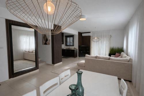 a living room with a table and a couch at Villa Dolce Vita in Protaras