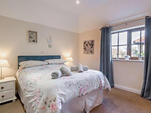 a bedroom with a bed and a window at 2 Bed in Norwich oc-64075 in East Harling