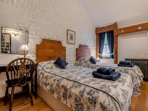 a bedroom with two beds with blue pillows on them at 4 Bed in Eastbourne oc-71297 in Eastbourne