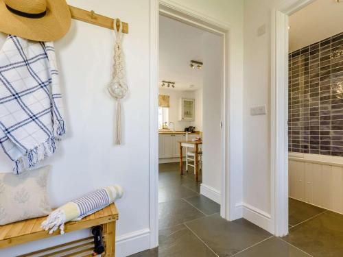 a hallway with a door leading into a kitchen with a table at 1 Bed in Helston oc-82496 in Ruan Minor
