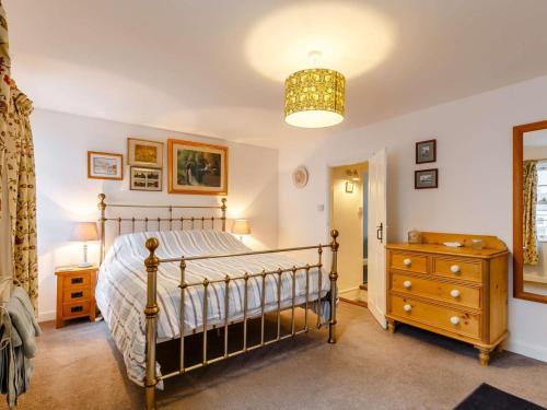 a bedroom with a bed and a dresser at 2 Bed in Fowey oc-76624 in Fowey