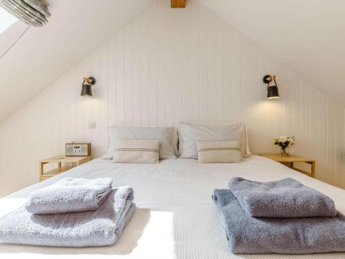 a bedroom with a white bed with two towels on it at 1 Bed in Helston oc-82496 in Ruan Minor