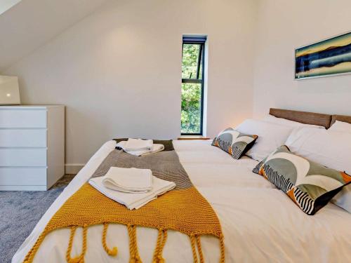 a bedroom with two beds with towels on it at 4 Bed in Bude oc-83619 in Stratton
