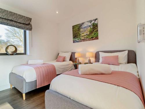 a bedroom with two beds and a window at 2 Bed in Colchester oc-95941 in East Bergholt
