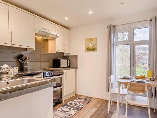 a kitchen with a sink and a stove top oven at 1 Bed in Norwich oc-76493 in East Harling