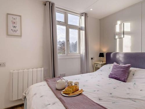 a bedroom with a bed with a tray of food on it at 1 Bed in Norwich oc-76493 in East Harling