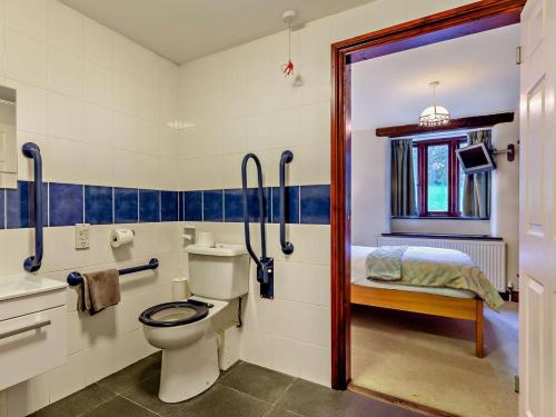a bathroom with a toilet and a sink and a bed at 4 Bed in Boscastle oc-47035 in Boscastle
