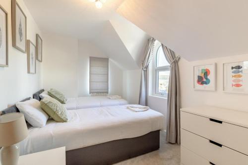 a white bedroom with a bed and a window at 2 Bed in Abersoch oc-p27804 in Abersoch