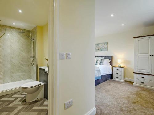 a bathroom with a bed and a shower and a toilet at 2 Bed in Spilsby oc-91141 in Skendleby