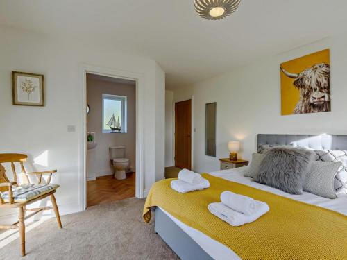 a bedroom with a large bed with two towels on it at 3 Bed in Spilsby oc-91142 in Skendleby
