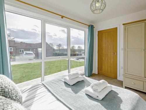 a bedroom with a bed and a large window at 3 Bed in Spilsby oc-91142 in Skendleby