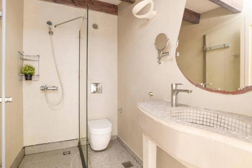 a bathroom with a shower and a sink and a toilet at Villa Chloe Seastone by Villa Plus in Kiotari
