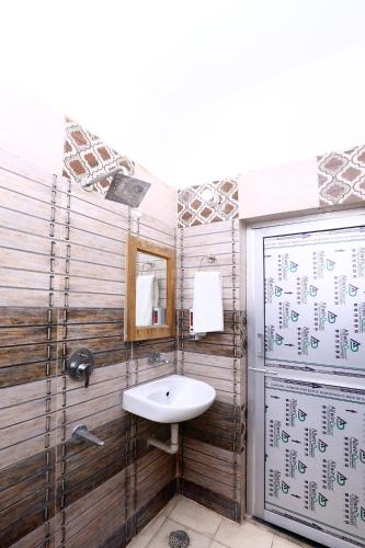 a bathroom with a sink and a mirror at Hotel S2 Residency Near Railway Station Chandigarh in Chandīgarh