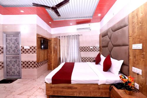 a bedroom with a large bed with red pillows at Hotel S2 Residency Near Railway Station Chandigarh in Chandīgarh