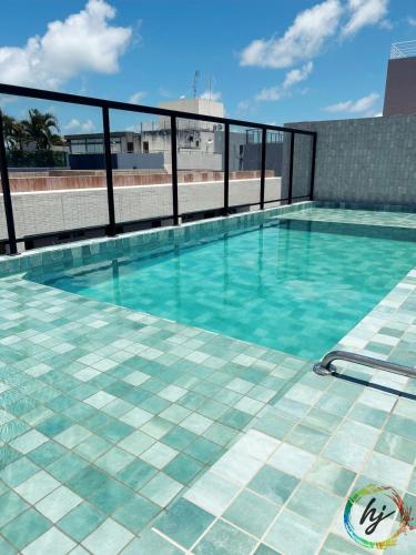 a swimming pool on the roof of a building at Mares Cabo Branco 507 in Tambaú