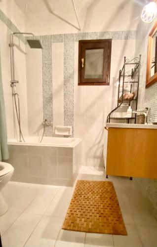 a bathroom with a tub and a sink and a shower at Koti Mountain House in Litochoro