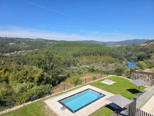 an aerial view of a swimming pool in a yard at Casa do Barbeiro - View of the River Minho in Melgaço