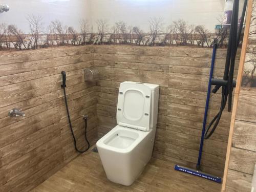 a bathroom with a toilet in a brick wall at Siva Residencies in Wattala