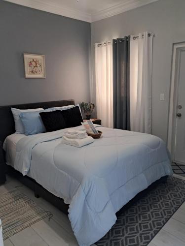 a bedroom with a large bed with white sheets at Marie view Rentals in Abaco