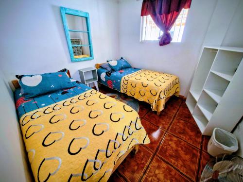 a bedroom with two beds and a mirror at MatSofy_Apartamento in Santiago